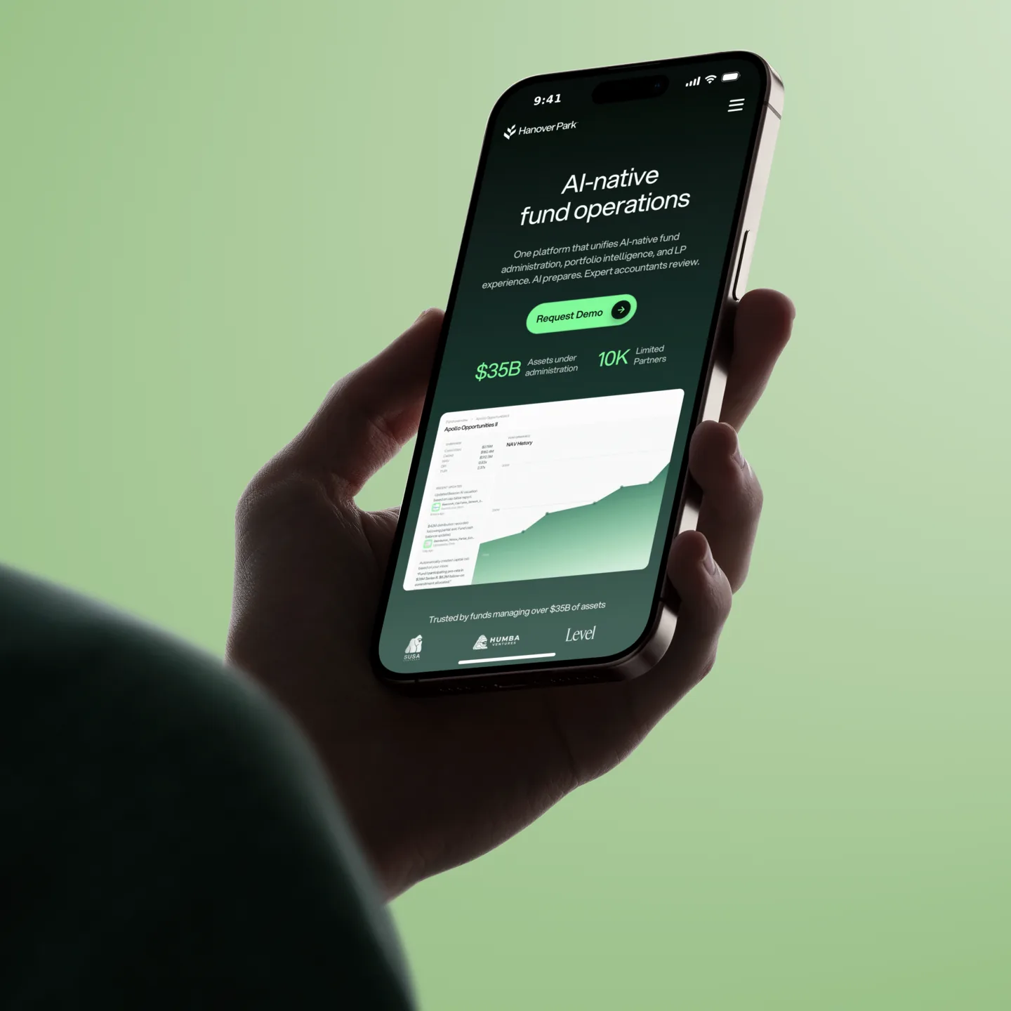 The Hanover Park homepage open on a phone held in one hand, against a green ground